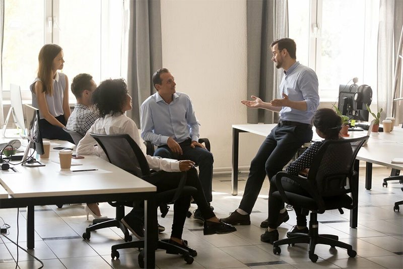 Leader talking to employee about business